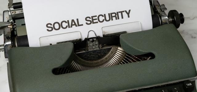a close up of a typewriter with a paper that says social security by Markus Winkler courtesy of Unsplash.